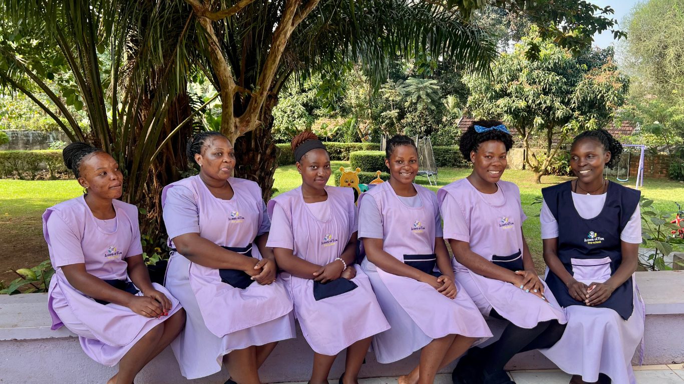 Acres of Fun teaching staff smiling together in the garden